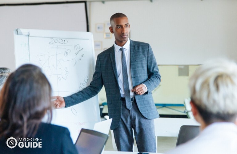 Business Operations Specialist presenting his report during a meeting