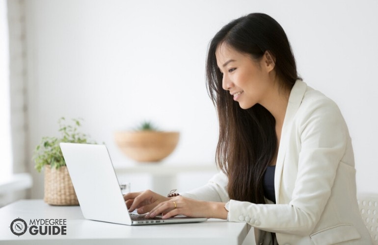 masters in health informatics degree student studying on her laptop