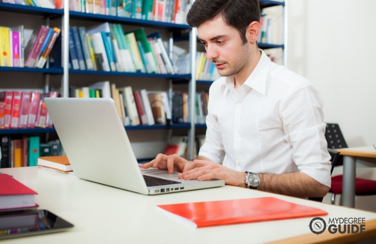 Healthcare Administration Degree student studying in a library