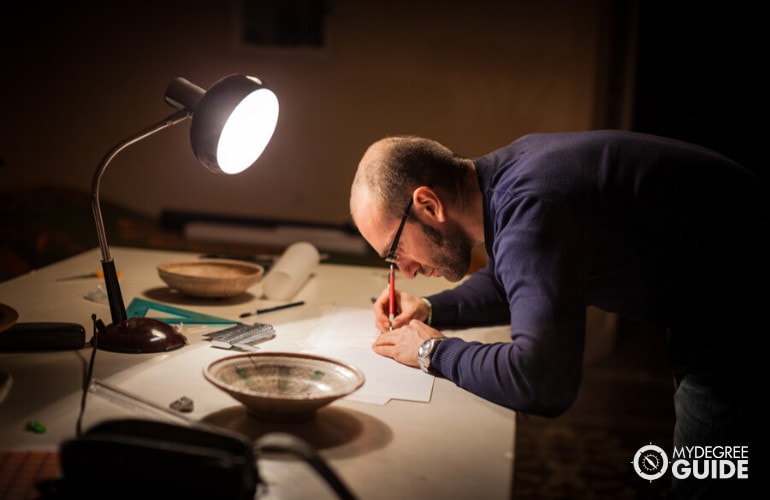 male historian examining artifacts