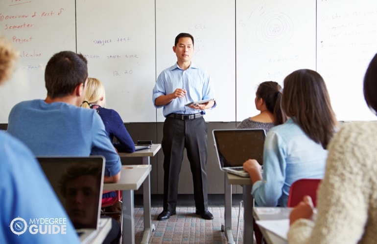 college professor teaching his students in class