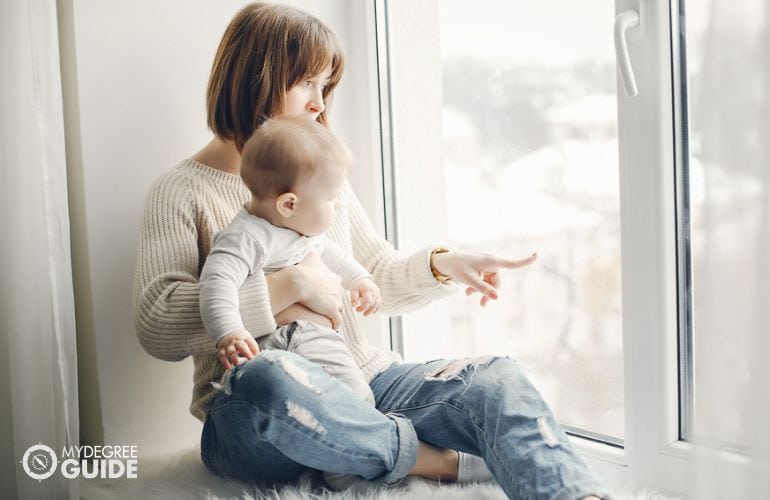 mother and son playing near window