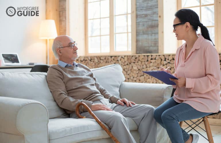 social worker talking to an elderly man