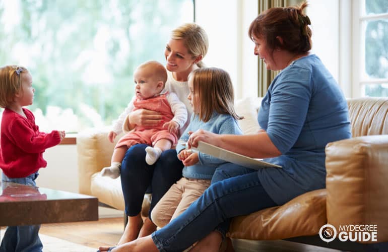 social worker interviewing a mother with her children in their home