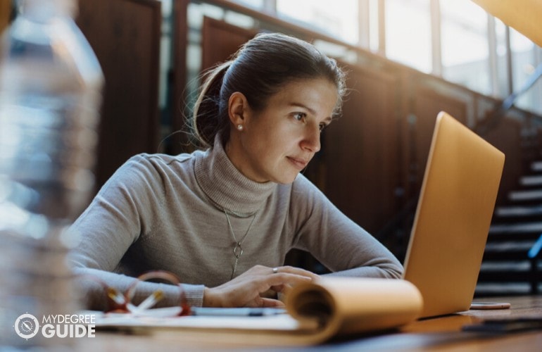 accounting student studying online in a library