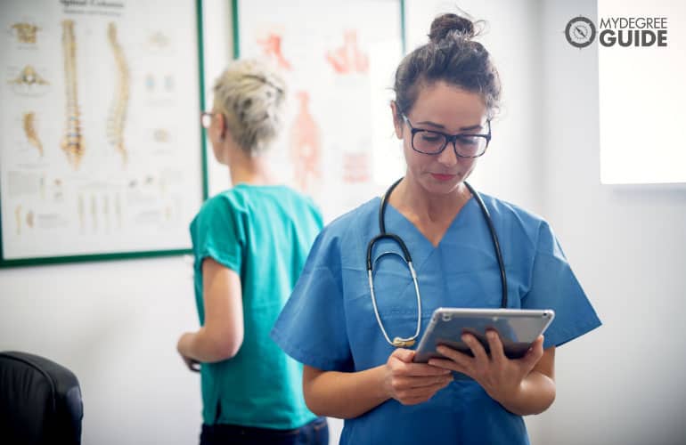 medical assistant looking at a tablet