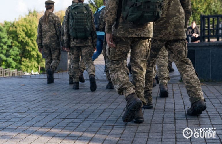 us military persons strolling around campus