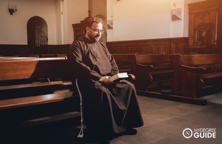 minister praying in the church