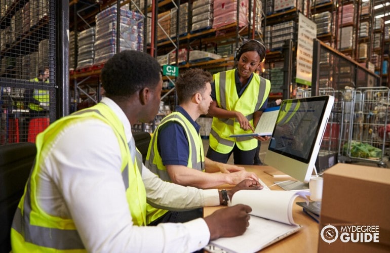 supply chain manager giving instructions to warehouse employees