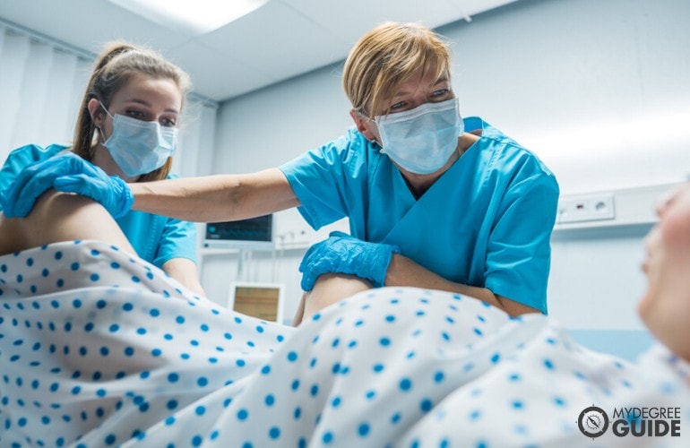 professional midwives helping a patient give birth