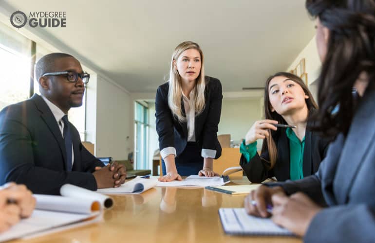 executive director of a nonprofit organization having a meeting with her subordinates