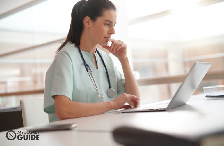 nurse studying on her laptop