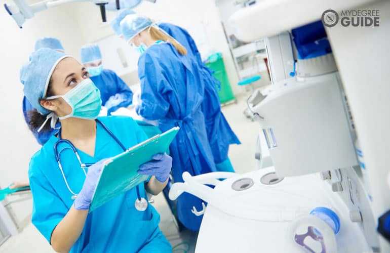 nurse checking patient's vital signs during operation