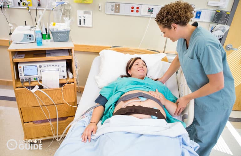 labor nurse comforting a patient in a hospital