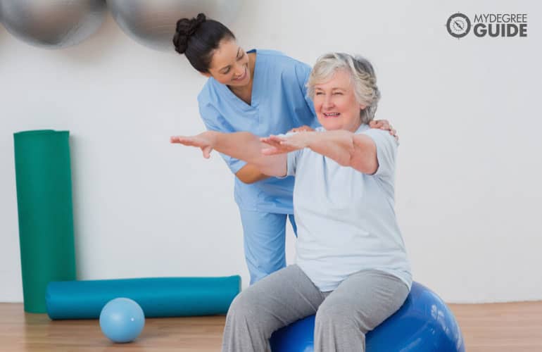 occupational therapist helping a patient during therapy session