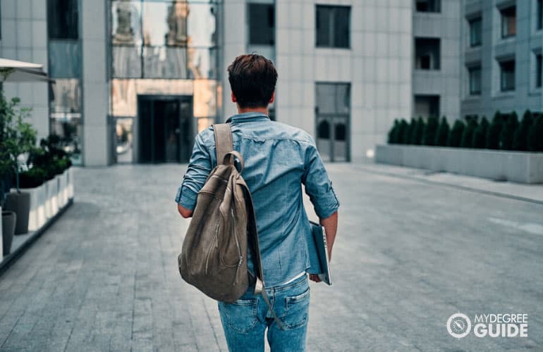 student walking into a school building