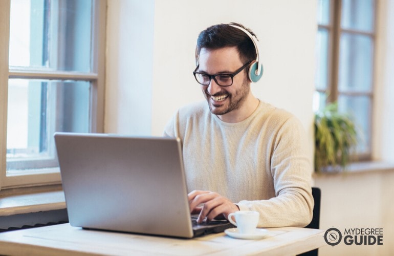 graphic design student studying on his laptop