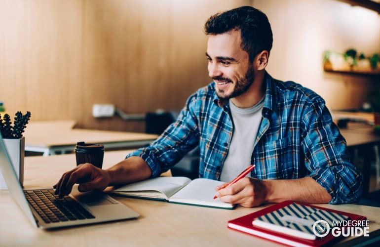 liberal arts student studying on his laptop