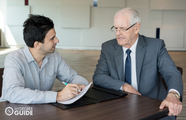 Executive Director discussing a project to his staff