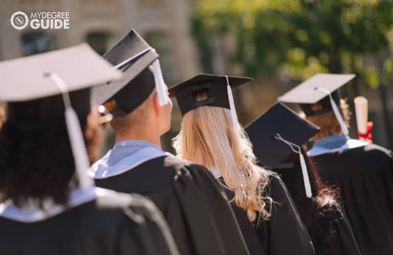 students receiving diploma during college graduation