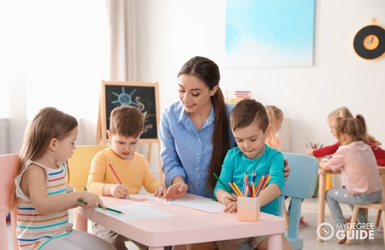 early childhood education teacher teaching her students in class