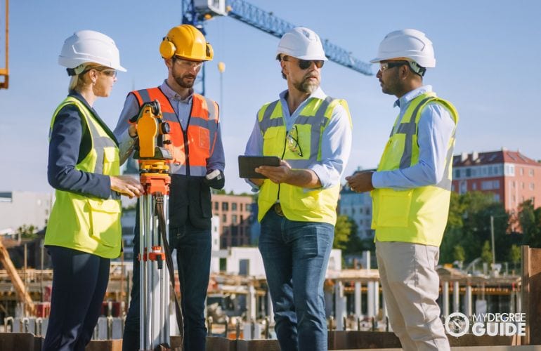 civil engineers discussing at construction site