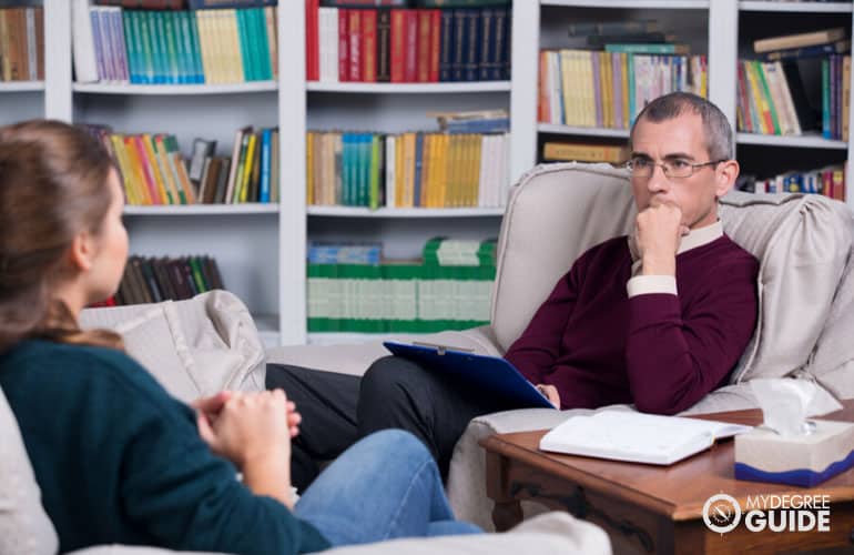 male counselor talking to a patient 