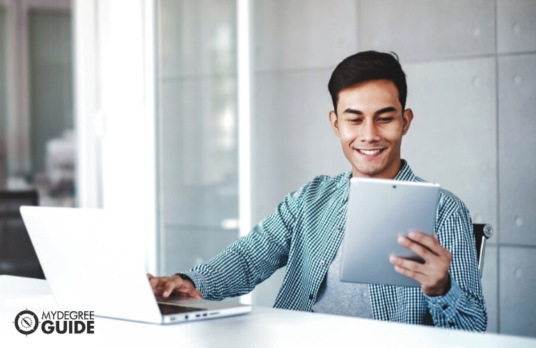 Masters in Public Administration student studying on his laptop