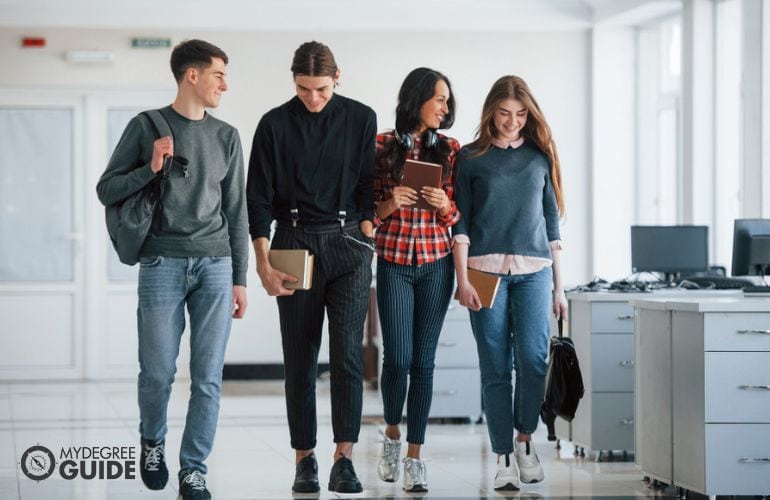 students walking across a college campus