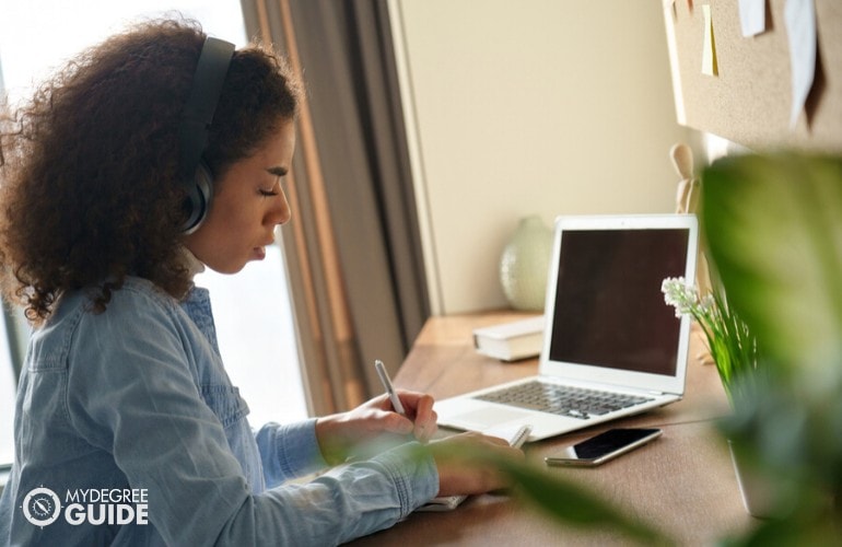 Bachelor of Music student studying on her laptop at home