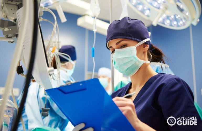 Registered nurse taking notes at the operating room