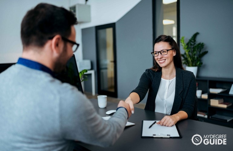 professional shaking hands with his employer