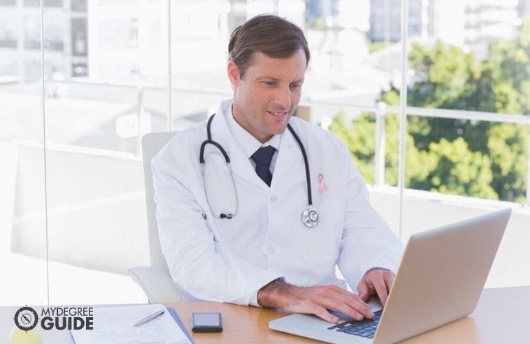 healthcare administrator working on his laptop