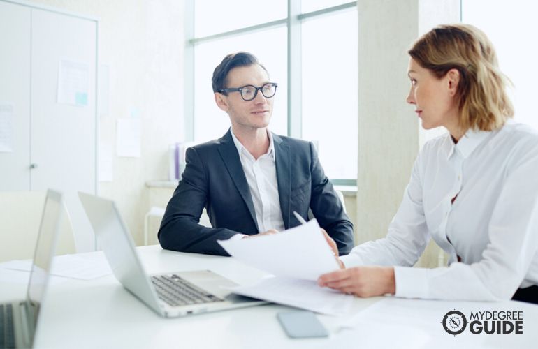 Public Relations Manager reviewing articles for publishing