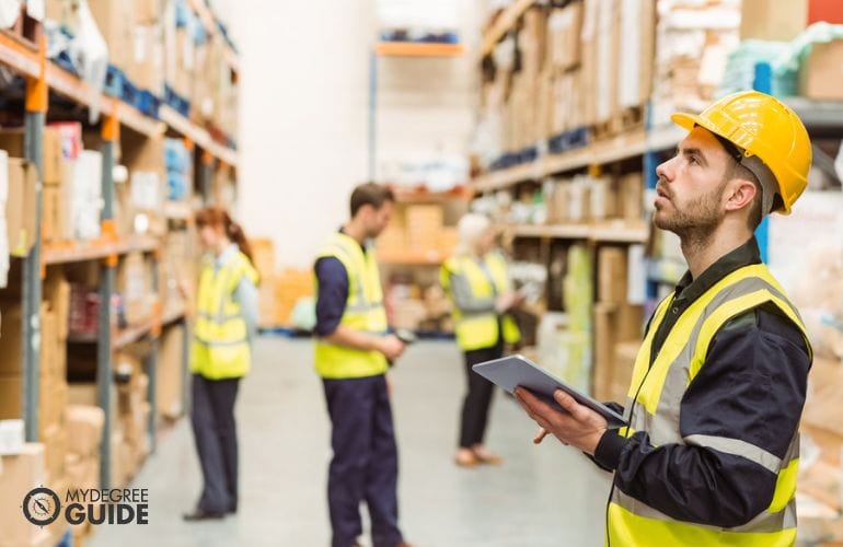 Logistics warehouse manager checking inventory