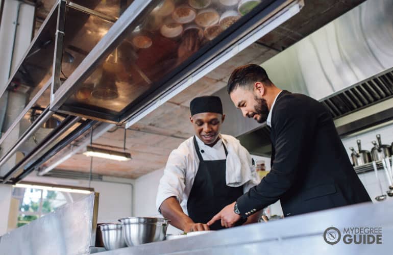 restaurant manager talking to a chef