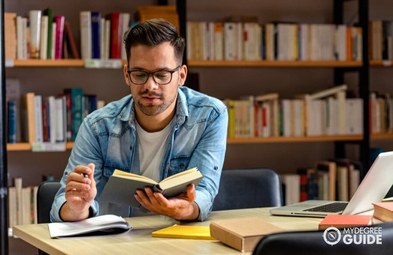 Organizational Leadership degree student studying in the library