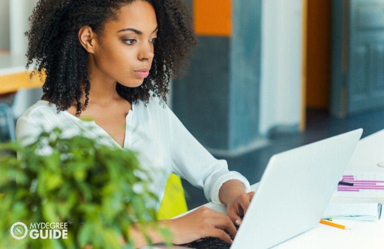 Organizational Leadership student studying on her laptop