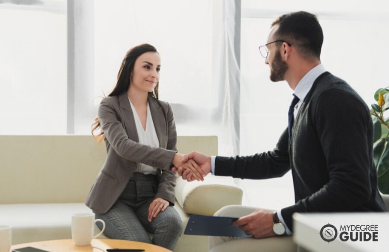 Organizational psychologists talking to a company's employee during a counseling session