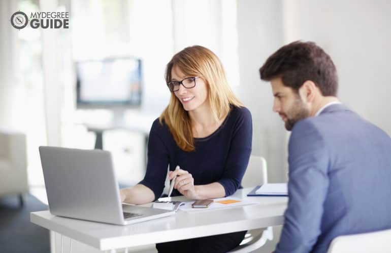 financial planner meeting with her client in an office