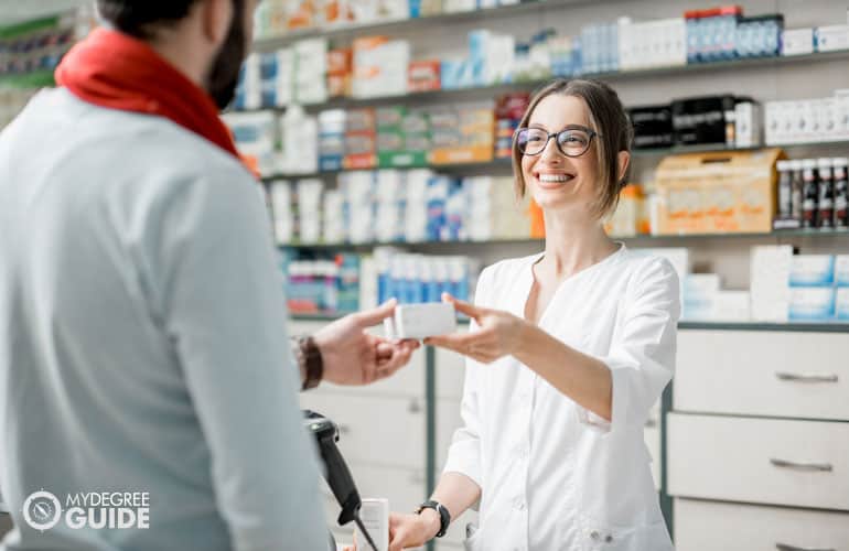 pharmacist giving medicine to a customer