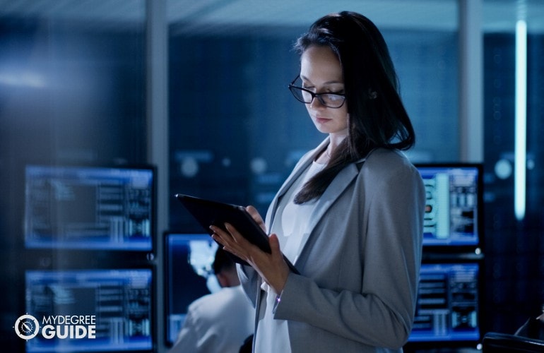 data administrator working on her tablet in data room