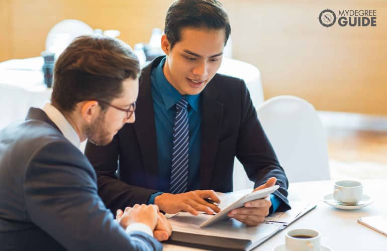 male consultant talking to a colleague