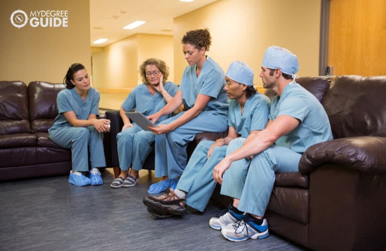 head nurse talking to fellow nurses in hospital