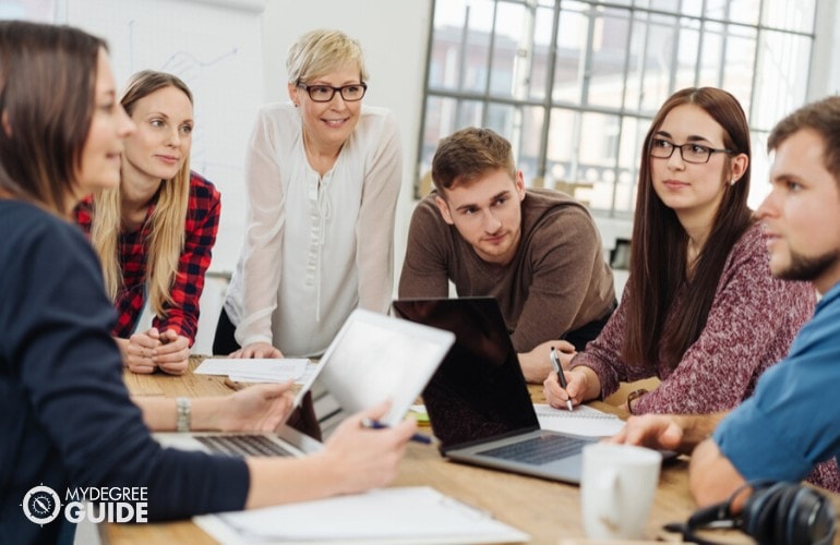 college professor with her students in class