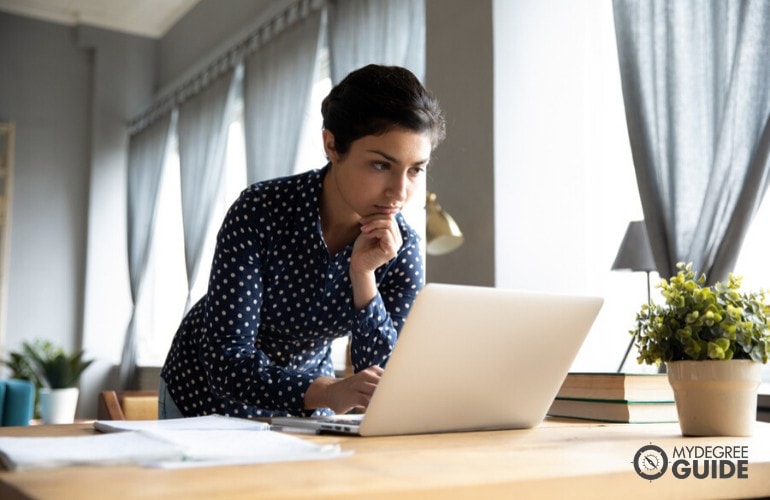 phd in psychology student studying on her laptop