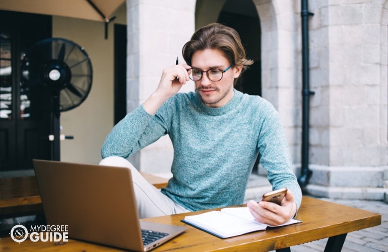 PhD in Public Administration student studying at a cafe