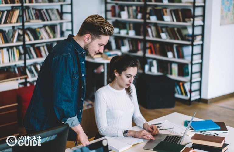 PhD students studying in a library