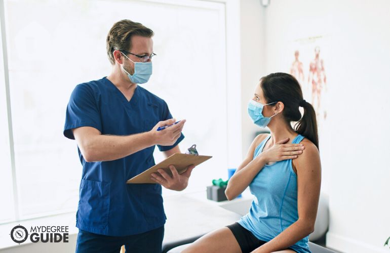 Physical Therapy Assistant educating patient about the treatment 