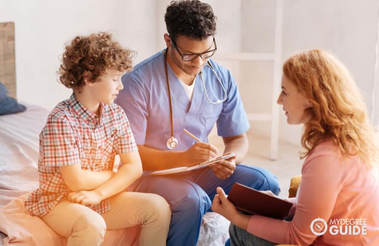 physician and his assistant talking to a patient